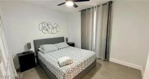 Recessed lighting, ceiling fan, and large window with privacy drapes
