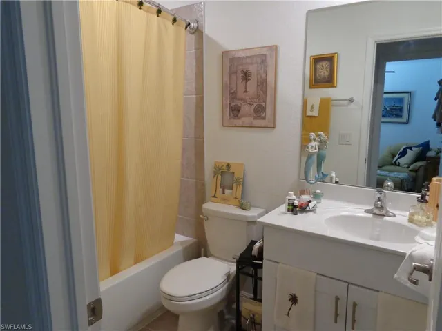Bathroom with vanity and shower / bathtub combination with curtain