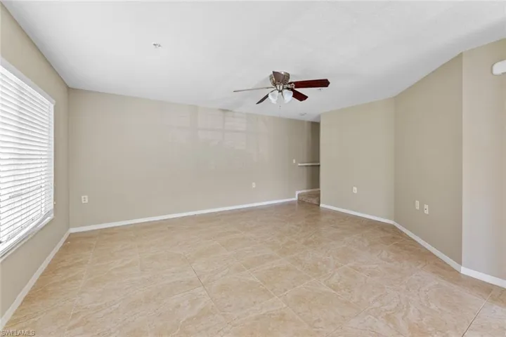 Empty room featuring a ceiling fan and healthy amount of natural light
