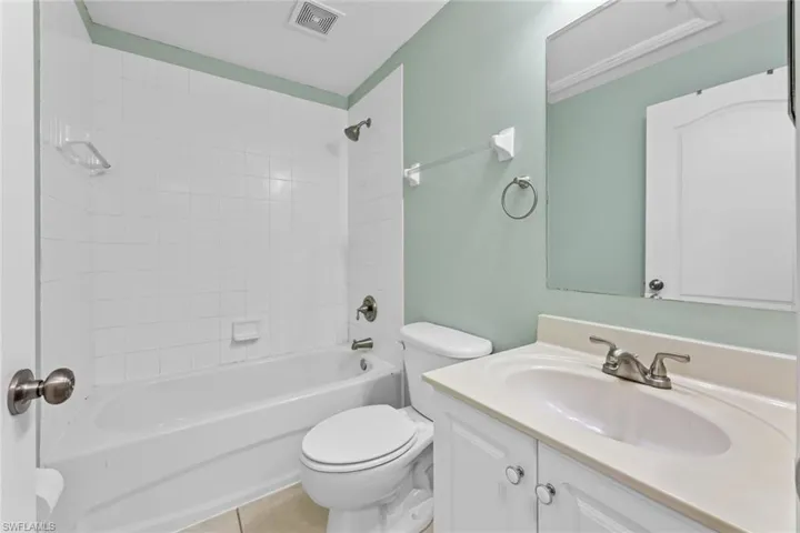 Full bathroom featuring vanity, shower / bath combination, and tile patterned flooring