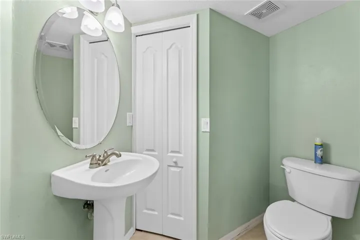 Half bath featuring toilet and baseboards