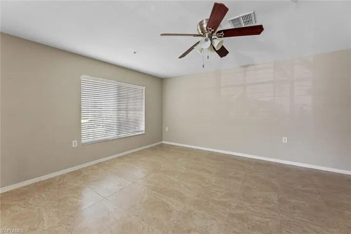 Unfurnished room featuring a ceiling fan