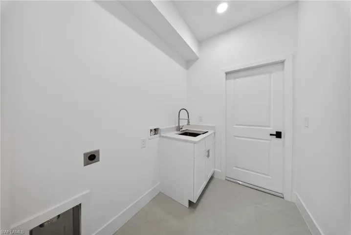 Laundry room with washer hookup, cabinet space, electric dryer hookup, and recessed lighting