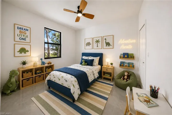 Bright room featuring a window with black trim, a ceiling fan with wood-finish blades, light gray flooring, a built-in wall closet, and recessed wall shelving