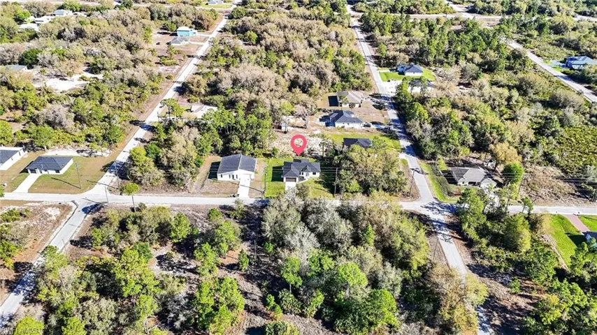 Aerial view of residential area featuring a tree filled landscape