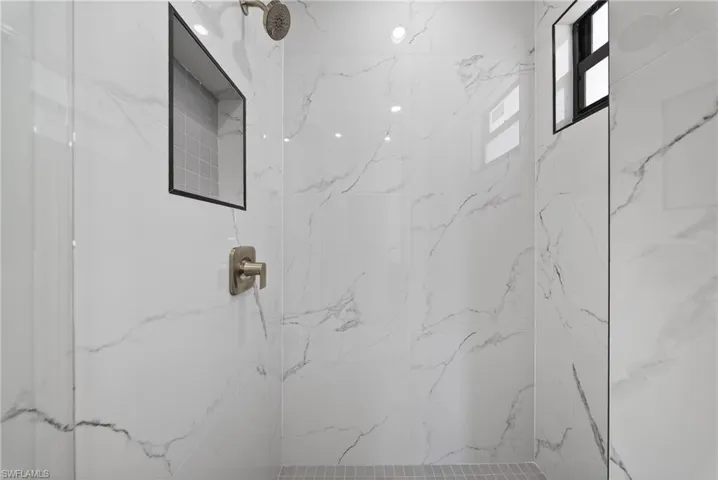Bathroom featuring a marble finish shower