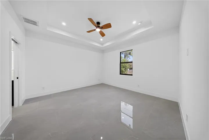 Unfurnished room featuring ceiling fan and baseboards