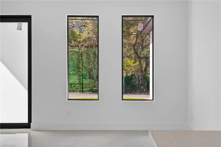 Unfurnished room featuring baseboards