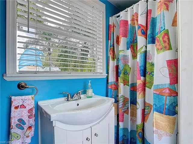 Bathroom with vanity and a shower with shower curtain