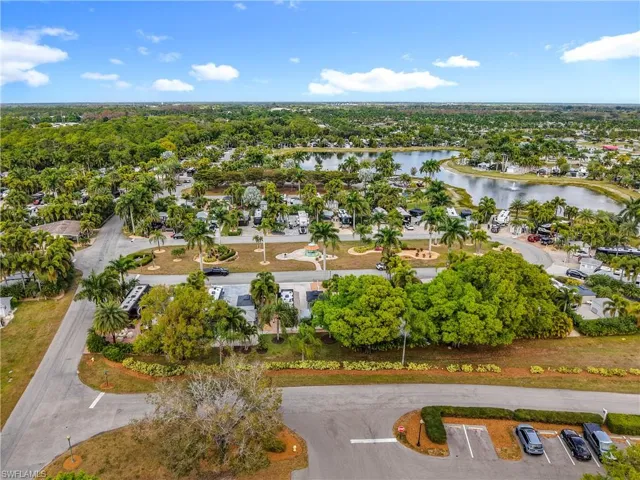 Aerial view of property and surrounding area featuring a large body of water and nearby suburban area