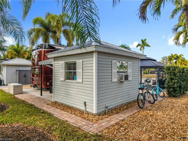 View of home's exterior featuring an outbuilding, a metal roof, a patio area, and a gazebo
