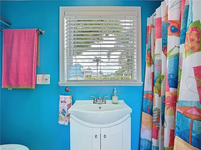 Bathroom featuring a shower with curtain and vanity
