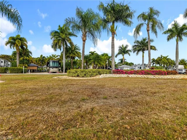 View of property's community with a lawn