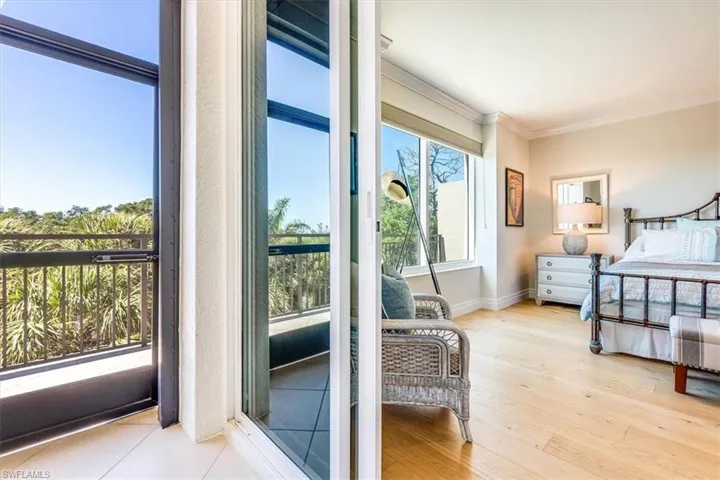 Primary bedroom with sliders to balcony