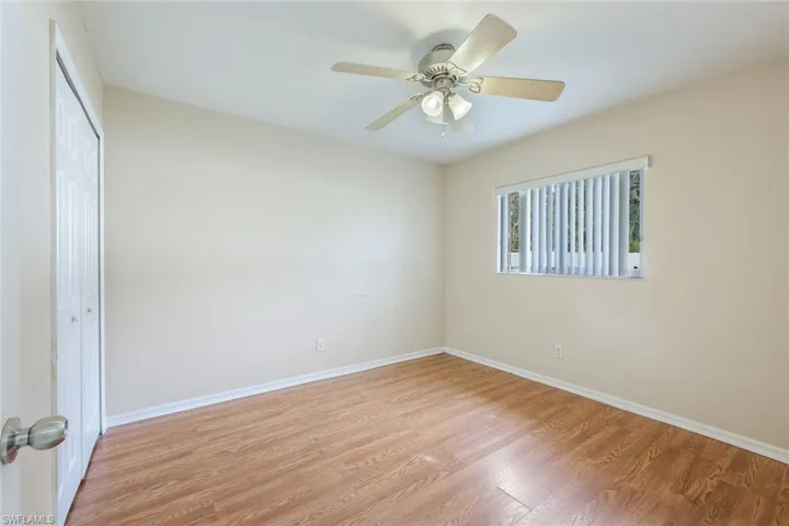 Empty room with light wood-type flooring and ceiling fan