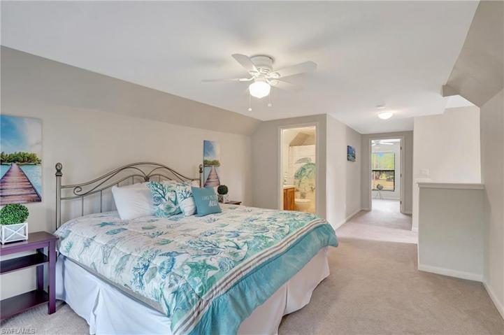 Primary bedroom with bath and screened in balcony