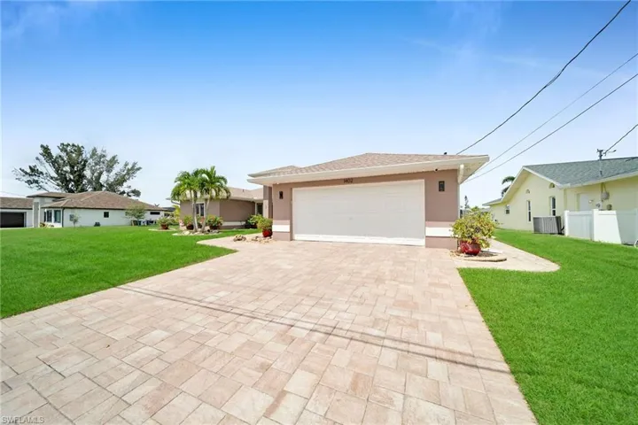 Single story home featuring a garage, central air condition unit, and a front lawn