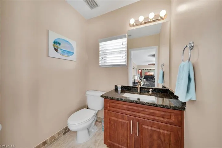 Bathroom featuring tile patterned floors, toilet, and vanity