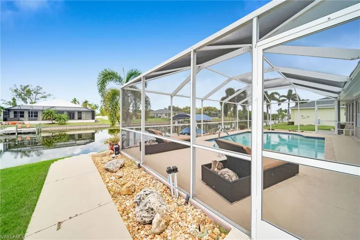 View of pool featuring a water view, a patio, and a lanai