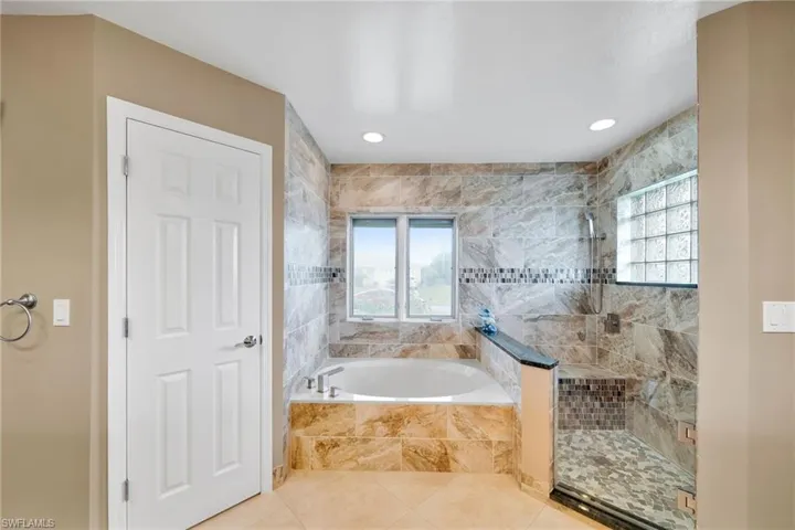 Bathroom featuring plus walk in shower and tile patterned floors
