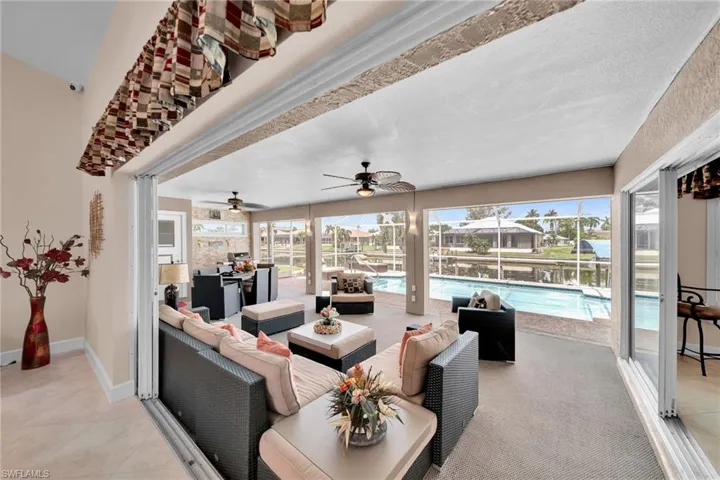 Tiled living room with a textured ceiling and ceiling fan