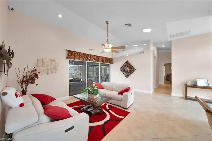 Living room featuring light tile patterned flooring and ceiling fan