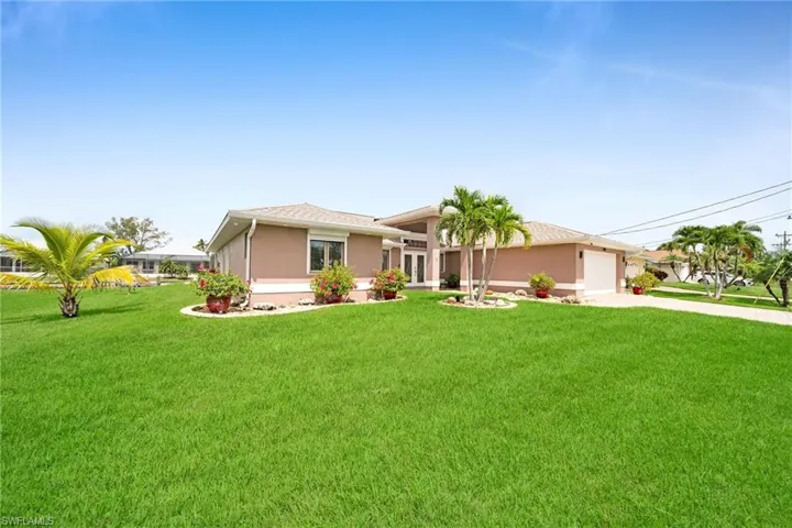 Ranch-style house with a garage and a front yard