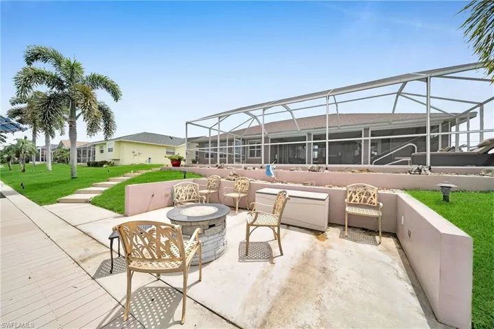 View of patio / terrace with a lanai and an outdoor fire pit