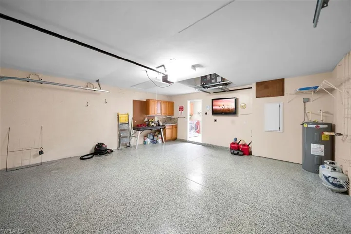 Garage with water heater and a garage door opener