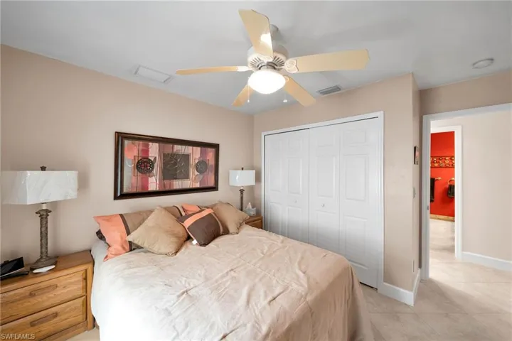 Tiled bedroom featuring a closet and ceiling fan
