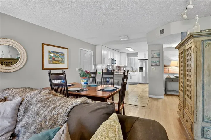 Dining area featuring a textured ceiling and light wood-style floors
