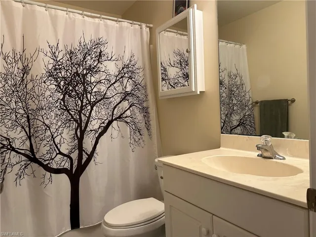 Full Guest bathroom featuring vanity, toilet, tile patterned flooring, and shower / bath combo