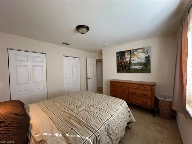 2nd Bedroom featuring carpet flooring and two closets