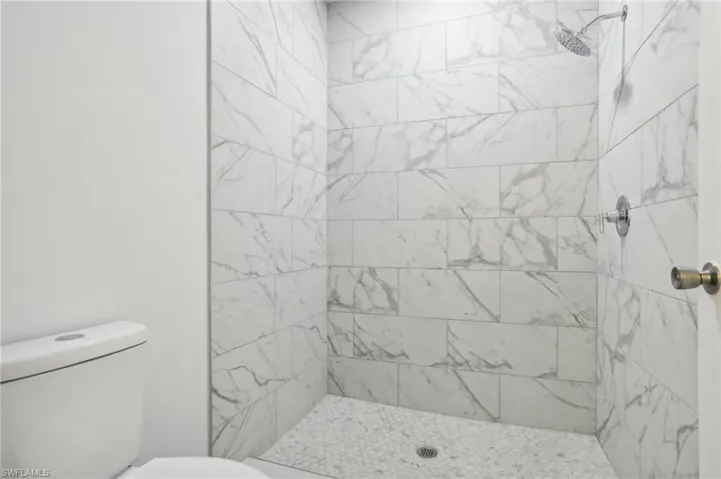 Bathroom featuring toilet and a tile shower