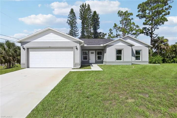 Single story home featuring a front lawn and a garage