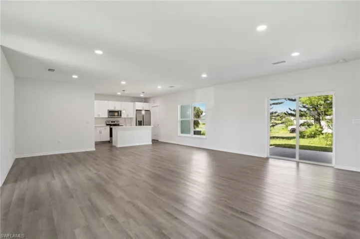 Unfurnished living room featuring wood-type flooring