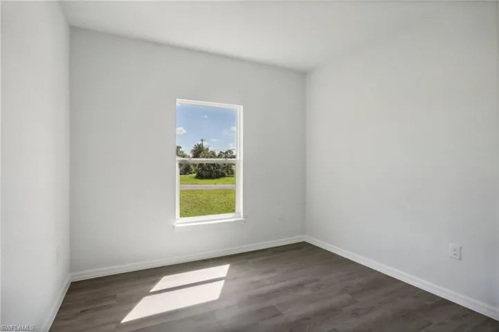 Empty room with hardwood / wood-style floors