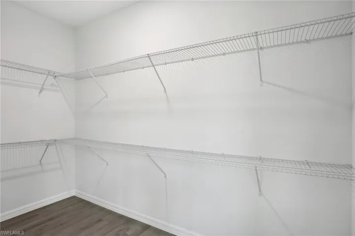 Walk in closet featuring hardwood / wood-style flooring