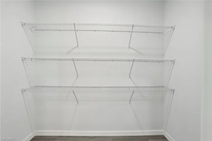 Walk in closet featuring hardwood / wood-style flooring