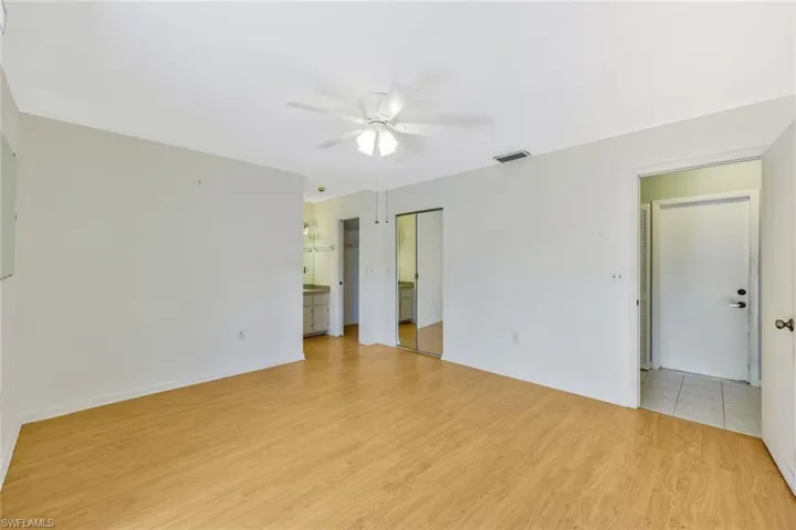 Empty room with light hardwood / wood-style flooring and ceiling fan