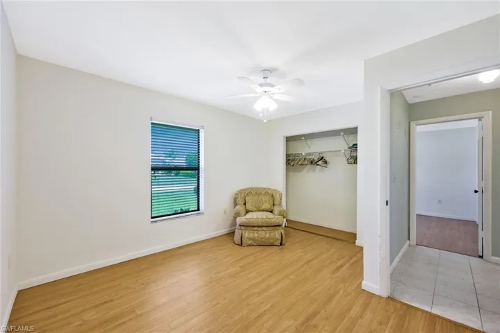 Living area with ceiling fan and light wood-type flooring