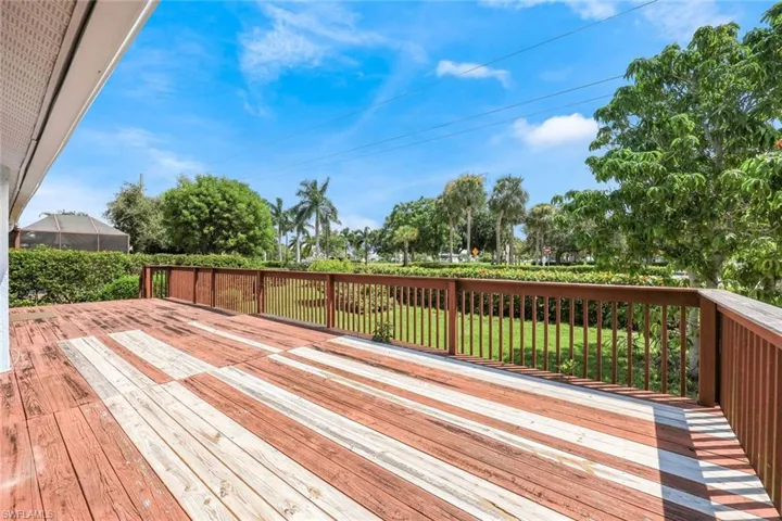 Wooden terrace featuring a lawn
