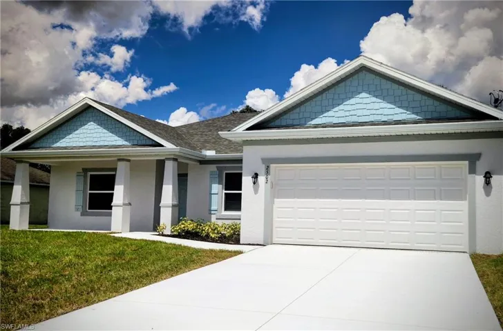 Craftsman inspired home featuring stucco siding, concrete driveway, a front yard, and a shingled roof