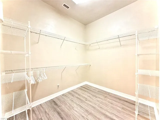 Walk in closet featuring hardwood / wood-style floors