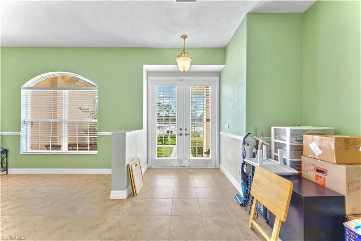 Tiled foyer entrance featuring french doors