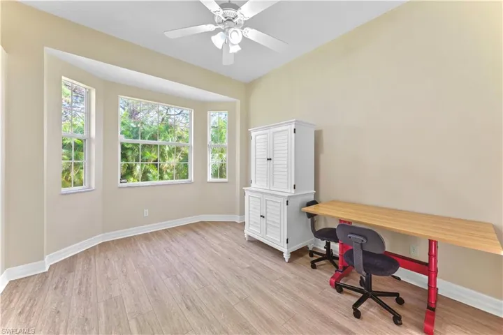 Home office featuring light hardwood / wood-style floors and ceiling fan