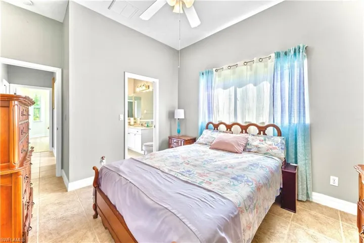 Bedroom featuring ceiling fan and connected bathroom