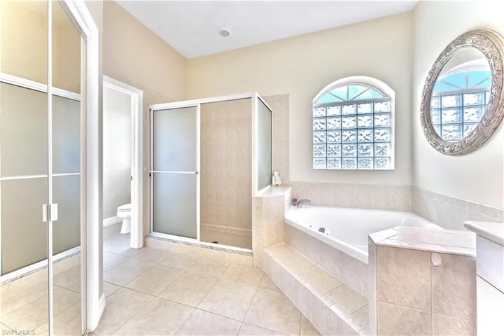Bathroom with plus walk in shower, tile patterned floors, and toilet