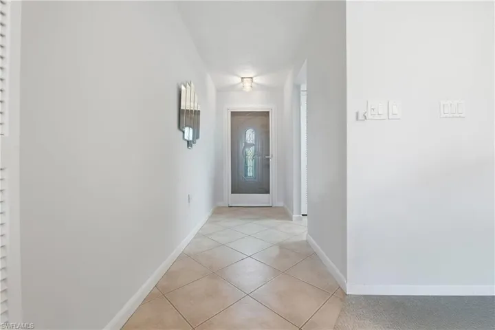 Tiled entry hall welcomes you at the leaded glass front door