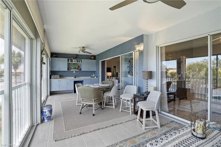 Sunroom / solarium with ceiling fan and an outdoor kitchen / dining area